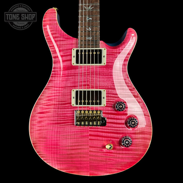 Pink electric guitar with a black background