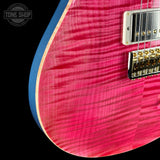 Close-up of a pink electric guitar with a visible brand logo in the corner.