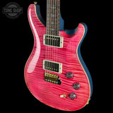 Pink electric guitar with a black background