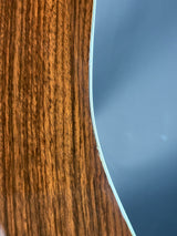 Close-up of a wooden surface with a metallic edge against a blue sky.