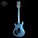 Blue electric guitar on a black background with 'Tone Shop' logo.
