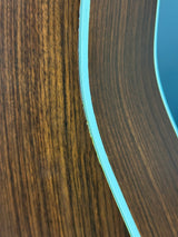 Close-up of a wooden surface with a blue strip running along its edge.