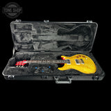 Yellow electric guitar in a black case with 'Tone Shop' logo.
