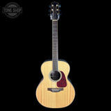 Acoustic guitar with a visible brand logo on a black background