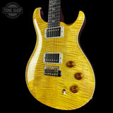 Yellow electric guitar with a black background