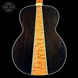 Close-up of a guitar's back and side with a visible brand logo in the corner.