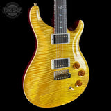 Yellow electric guitar with a black background