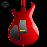 Red electric guitar body with a visible brand logo in the corner.