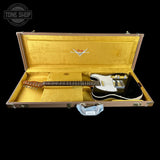 Electric guitar in a gold case with Fender logo, Tone Shop branding.