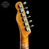Close-up of a guitar neck with tuning pegs on a black background, featuring the Tone Shop logo.