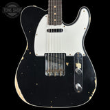 Black electric guitar with white pickguard on a black background, featuring 'Tone Shop' logo.