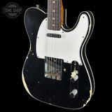 Black electric guitar with white pickguard on a black background, featuring 'Tone Shop' logo.