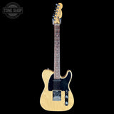 A natural wood Fender Telecaster electric guitar with a black pickguard and chrome hardware, shown against a solid black background with a Tone Shop watermark in the top left corner.