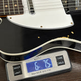 Guitar on a digital scale displaying weight
