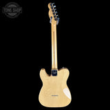 Fender Telecaster electric guitar shown from the back, featuring a natural light wood finish and a black tailpiece, photographed against a solid black background with a Tone Shop watermark in the top left corner.