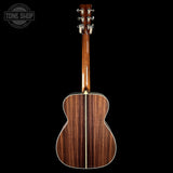 Wooden acoustic guitar on a black background with 'Tone Shop' logo.