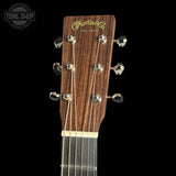 Guitar headstock with Martin & Co logo on a black background