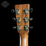 Close-up of a guitar headstock with tuning pegs on a black background, featuring the Tone Shop logo.