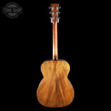 Wooden acoustic guitar on a black background with 'Tone Shop' logo.