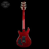 Red electric guitar on a black background with 'Tone Shop' logo.