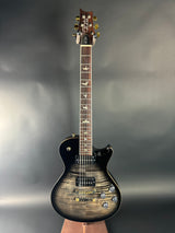 Electric guitar with a sunburst finish on a reflective surface