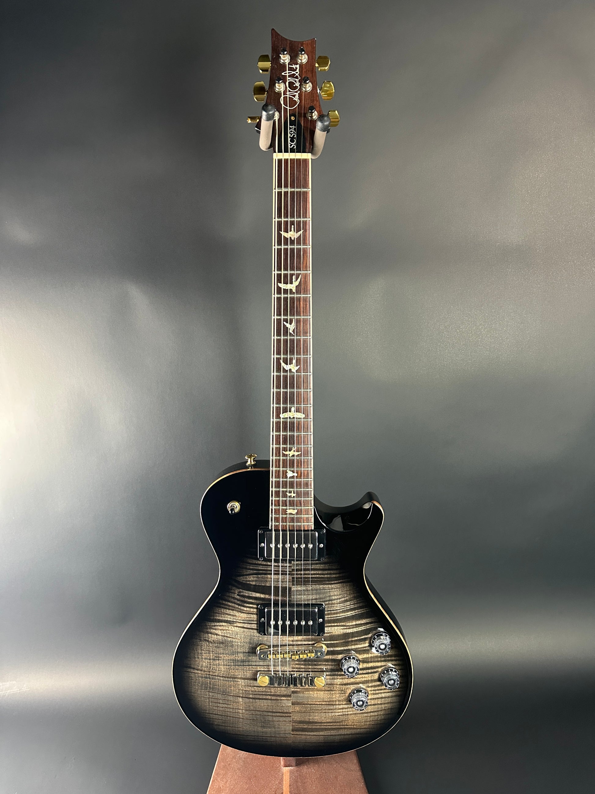 Electric guitar with a sunburst finish on a reflective surface