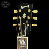 Gibson guitar headstock with brand logo on a black background