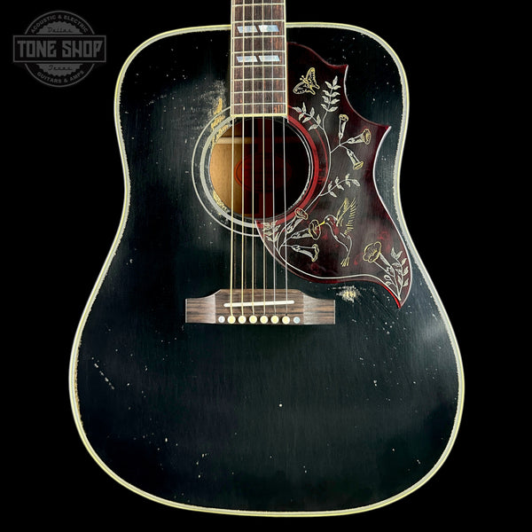 Black acoustic guitar with decorative inlay on a black background, featuring 'Tone Shop' logo.