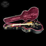 Gretsch guitar in a black case with 'Tone Shop' logo.