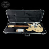 Electric guitar in a hard-shell case with 'Tone Shop' branding.