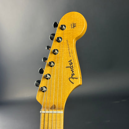 Close-up of a Fender guitar headstock on a gray background