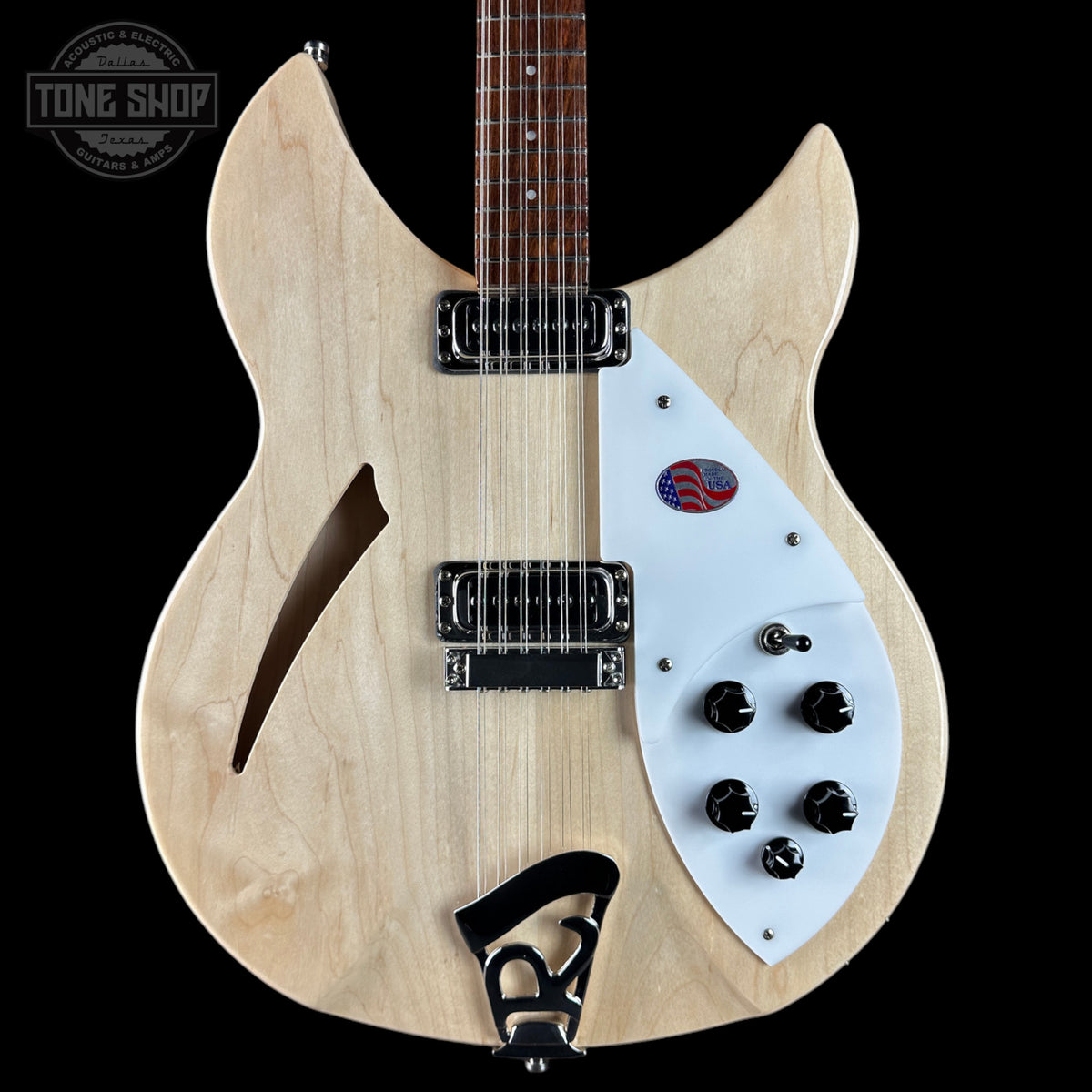Electric guitar with a white pickguard and visible brand logo on a black background