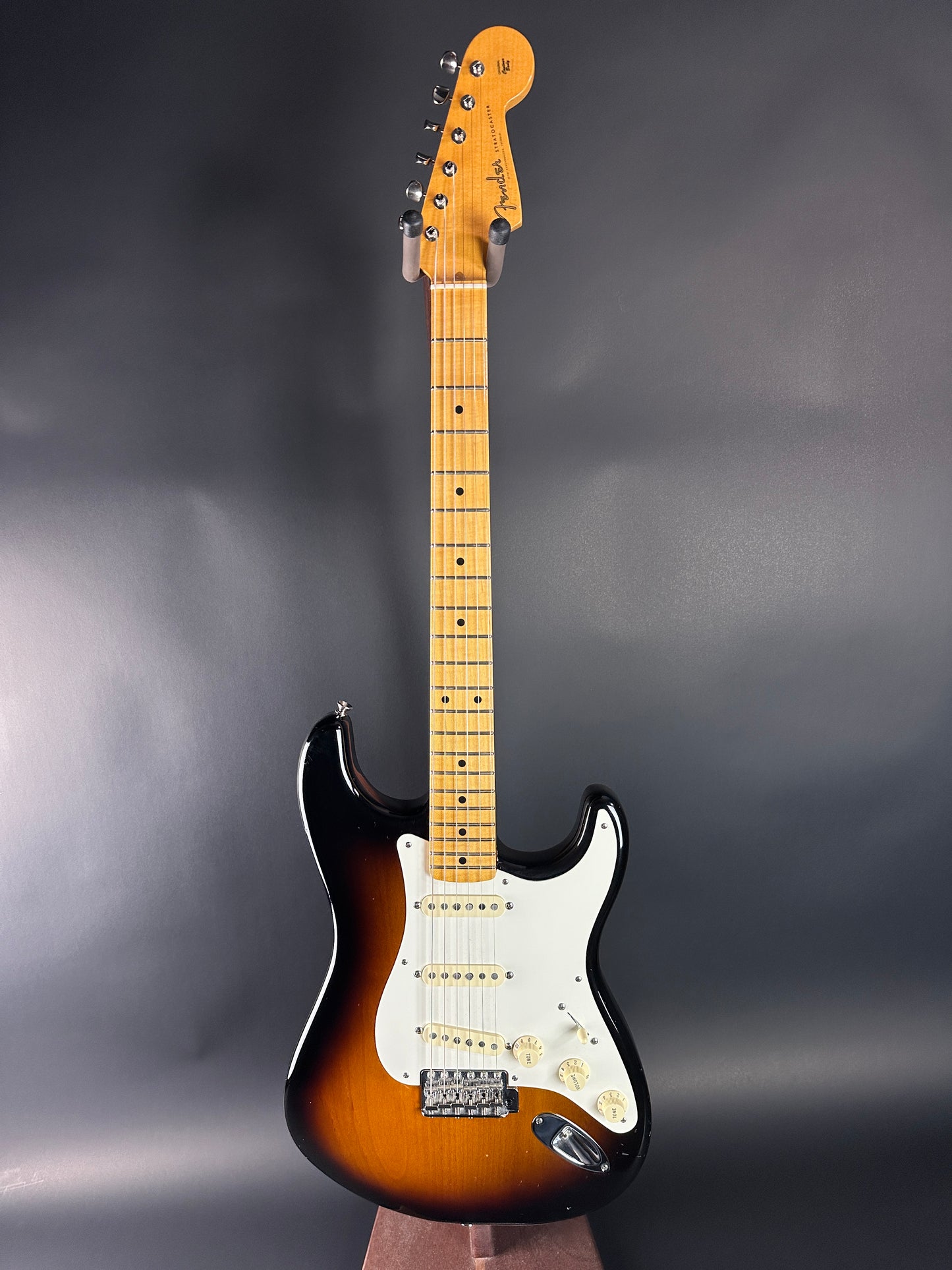 Electric guitar with a sunburst finish on a gray background