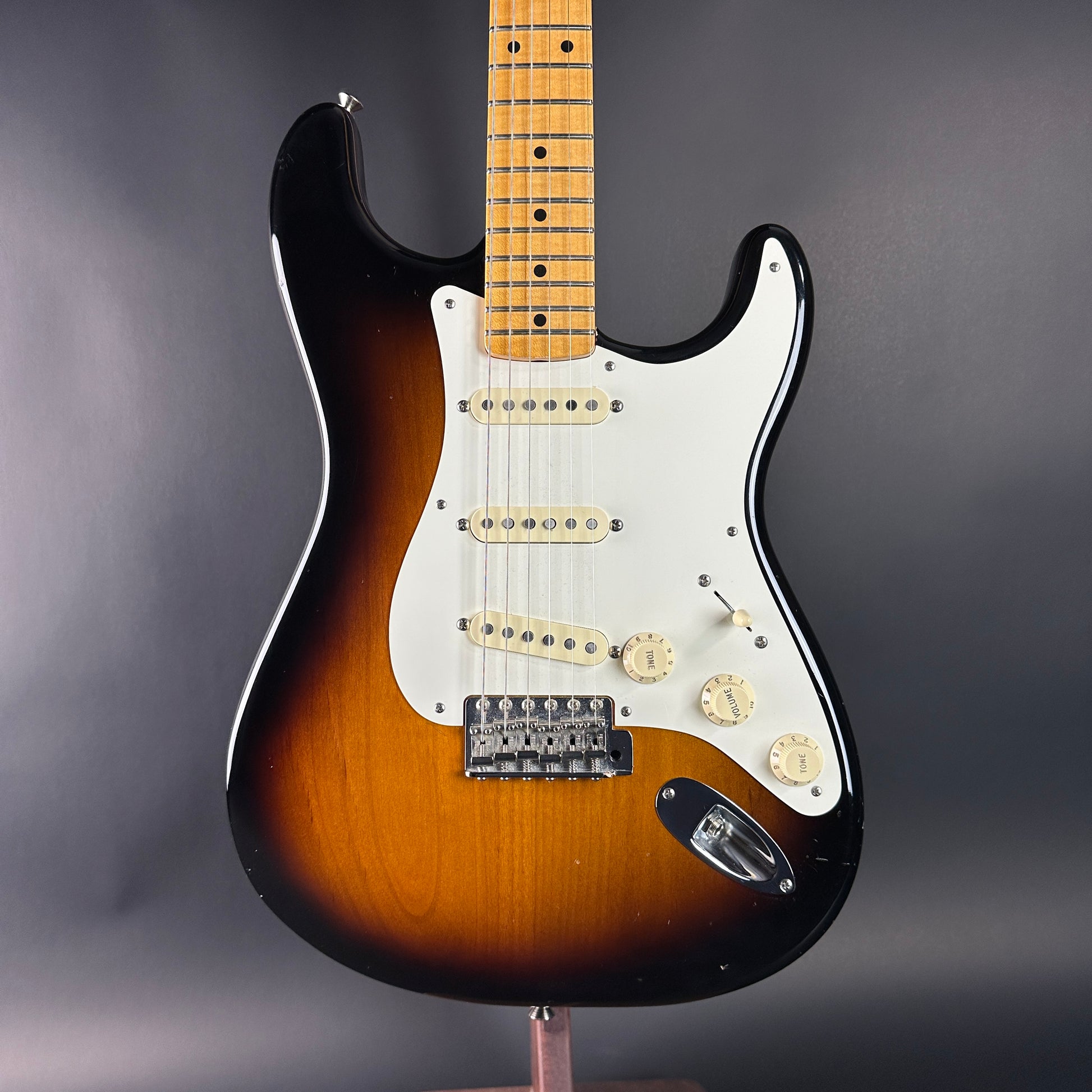 Electric guitar with a sunburst finish on a gray background