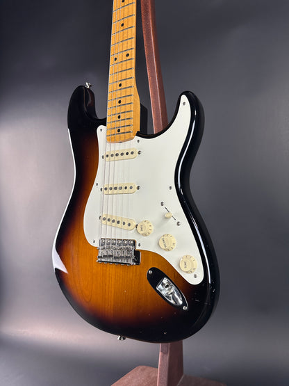 Electric guitar with a sunburst finish on a dark background