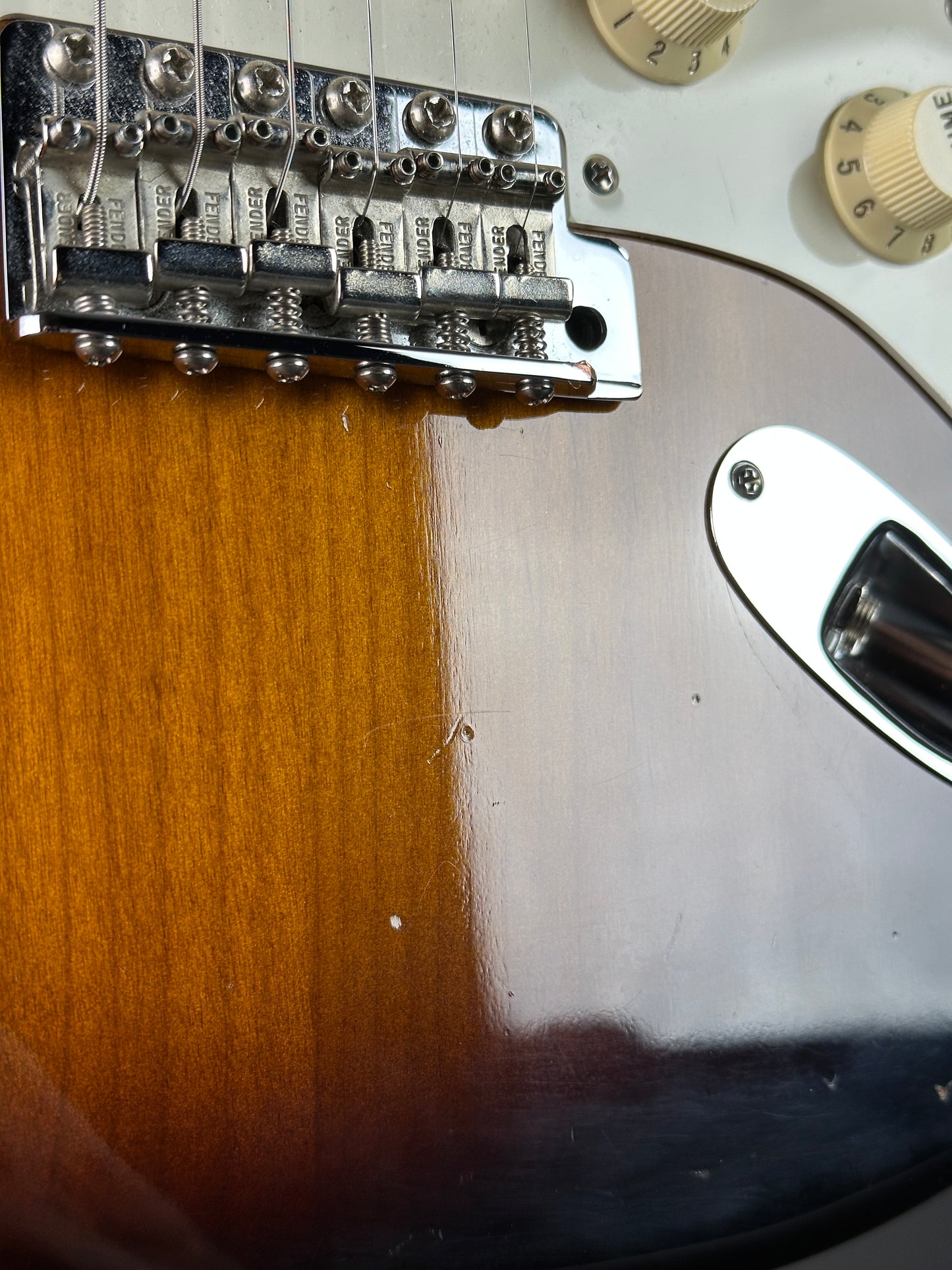 Close-up of a guitar's bridge and part of the body