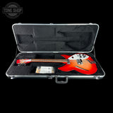Red electric guitar in a hard-shell case with 'Tone Shop' logo.