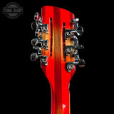 Close-up of a red electric guitar headstock with tuning pegs on a black background, featuring 'Tone Shop' branding.