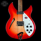 Electric guitar with a red and white design on a black background, featuring the Tone Shop logo.