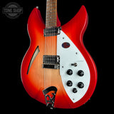 Red and white electric guitar with 'Tone Shop' logo in the corner