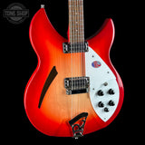 Red and white electric guitar with a black background