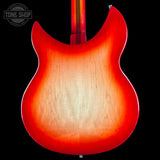 Close-up of a red electric guitar body with a blurred background