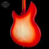 Close-up of a red electric guitar with a black background