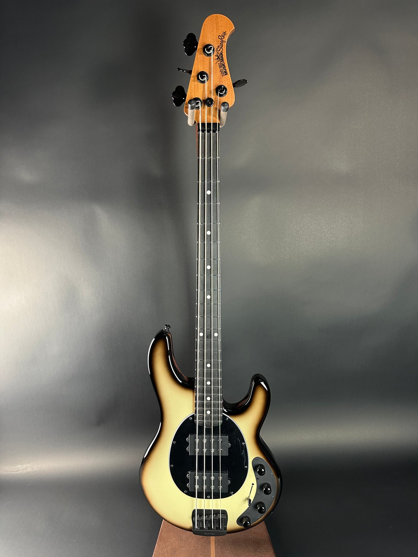 Electric bass guitar on a gray background