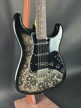 Guitar with intricate design on a dark background