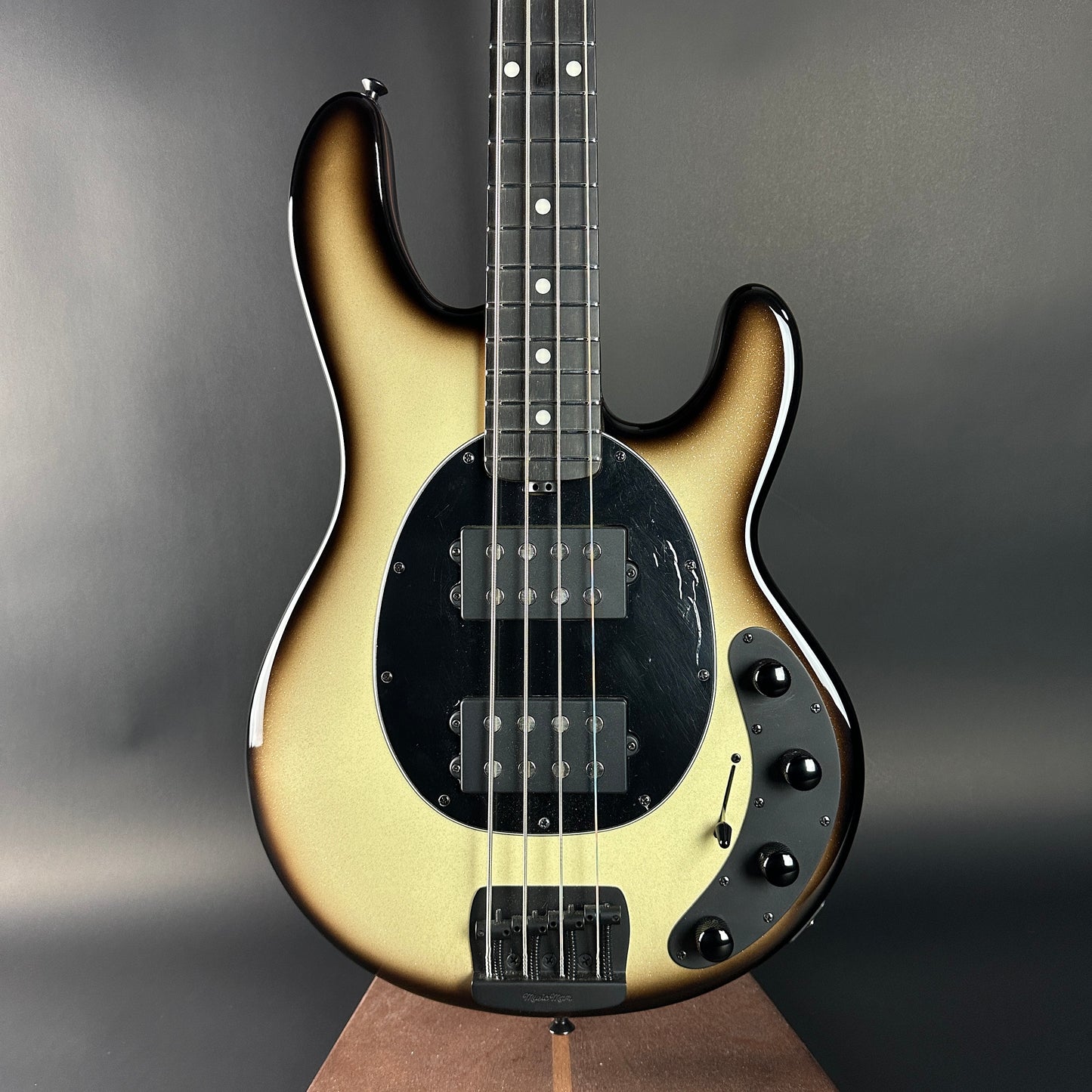 Electric bass guitar with a sunburst finish on a gray background