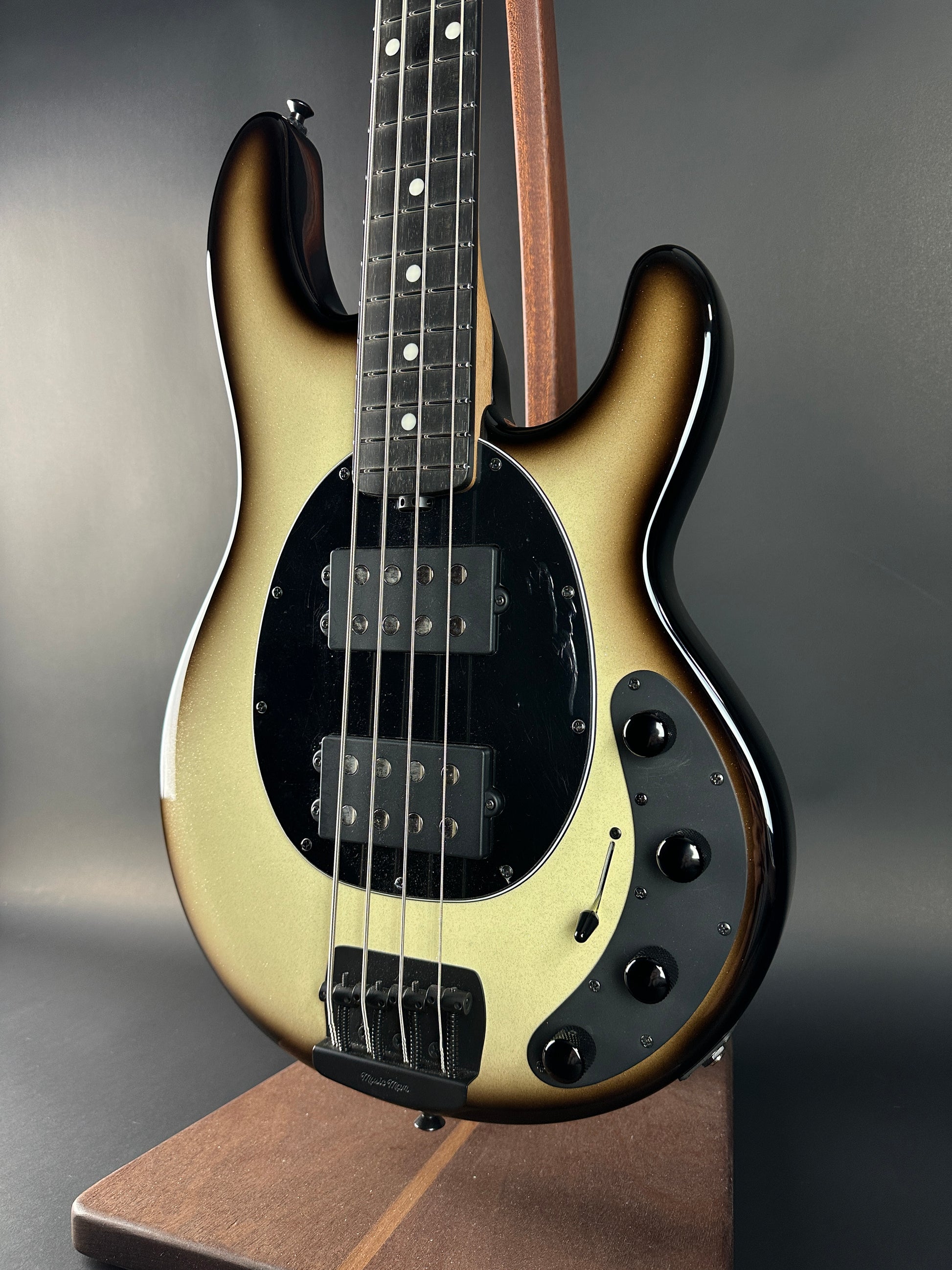 Electric bass guitar with a sunburst finish on a gray background
