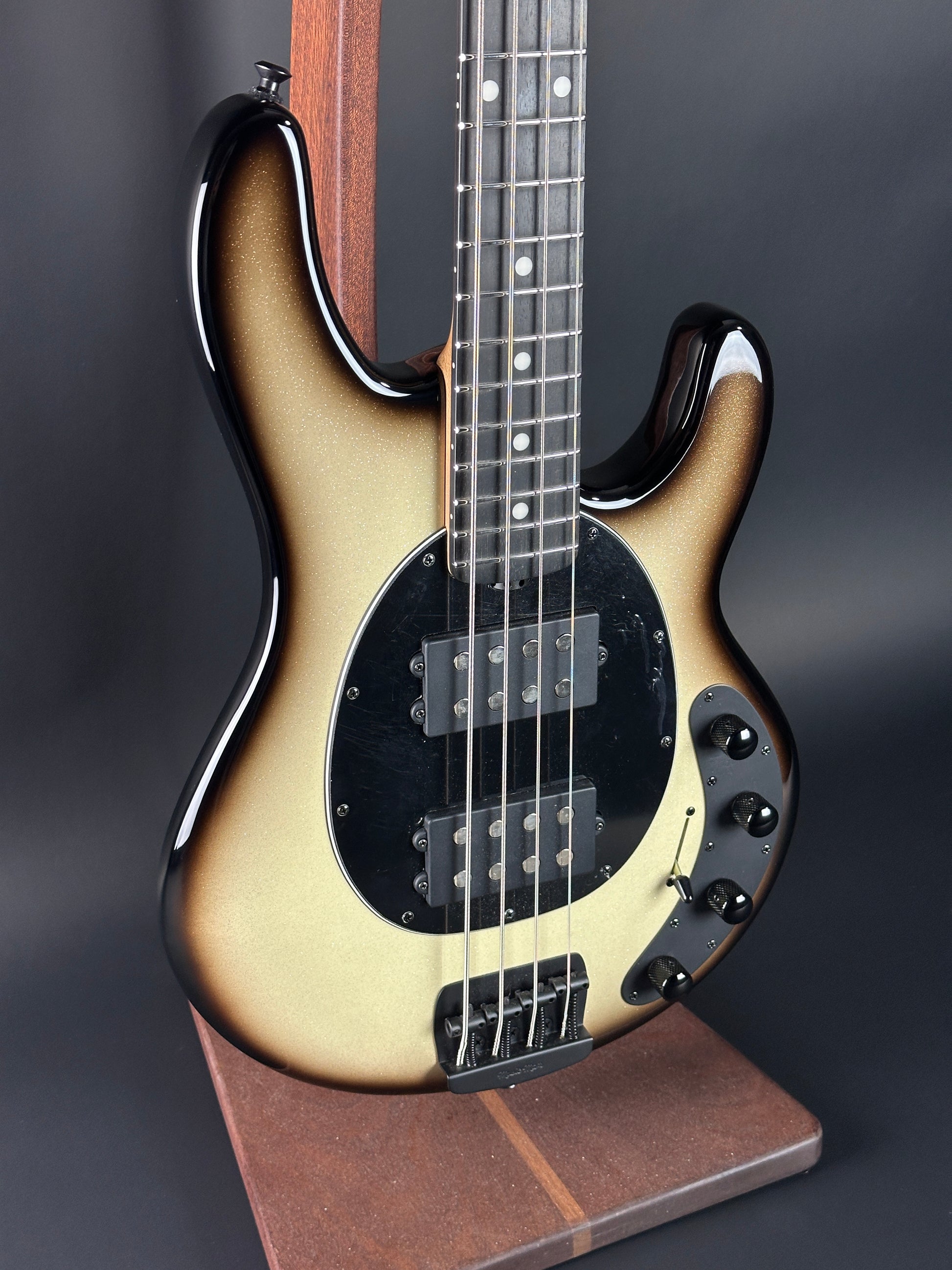 Electric bass guitar with a sunburst finish on a dark background