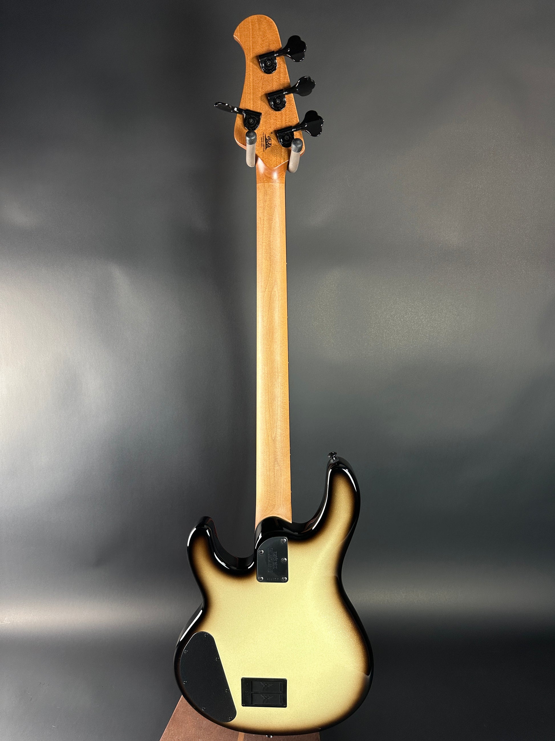 Electric bass guitar on a gray background