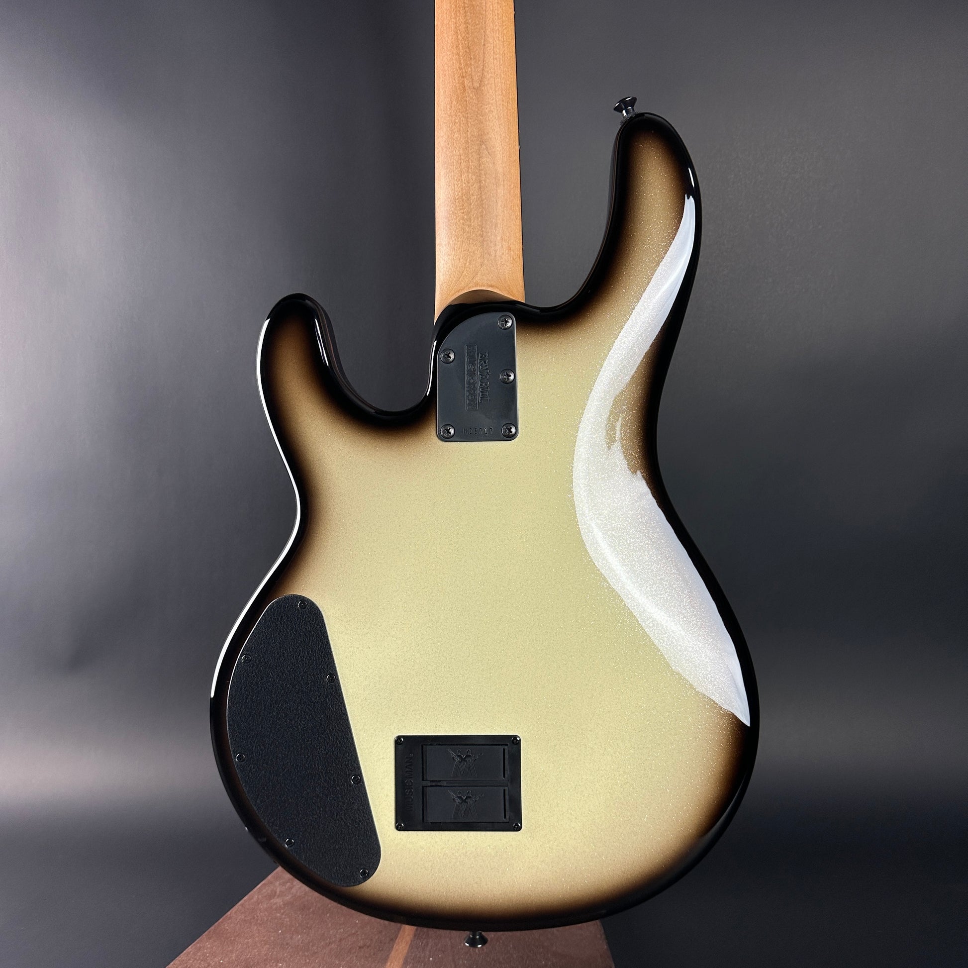 Electric bass guitar with a sunburst finish on a dark background